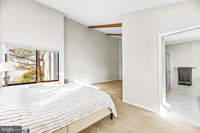 bedroom featuring light carpet and a textured ceiling