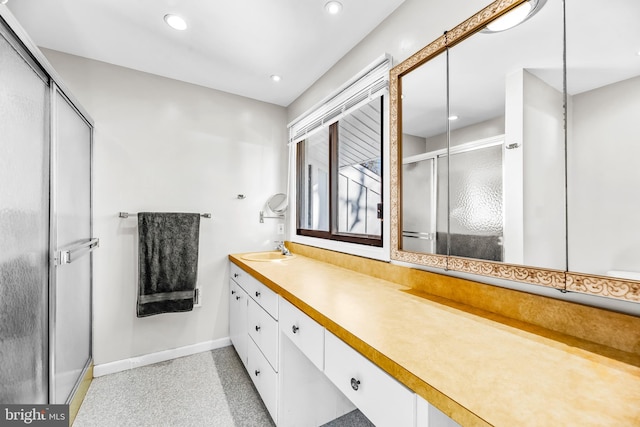 bathroom with vanity and a shower with shower door