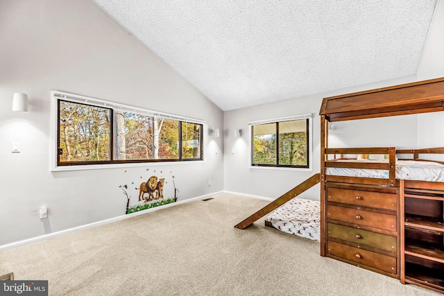 bedroom featuring a textured ceiling, light colored carpet, and lofted ceiling