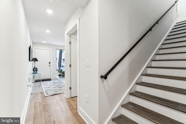 staircase with hardwood / wood-style flooring