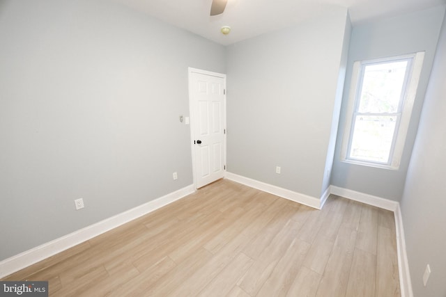 empty room with light hardwood / wood-style flooring and ceiling fan