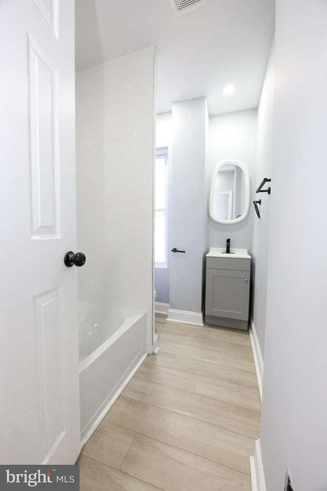 bathroom with vanity and hardwood / wood-style floors