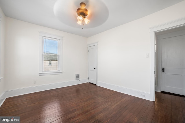 spare room featuring ceiling fan and dark hardwood / wood-style flooring