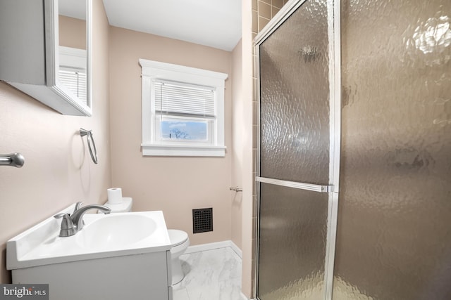 bathroom featuring toilet, vanity, and walk in shower