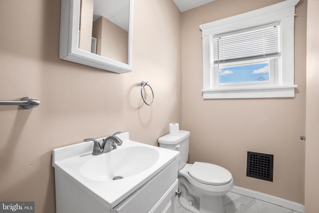 bathroom featuring toilet and vanity