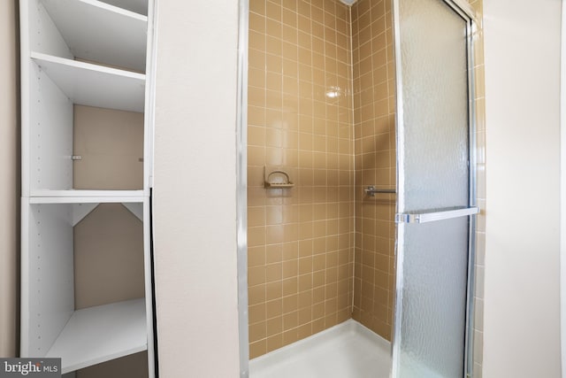 bathroom featuring a shower with door