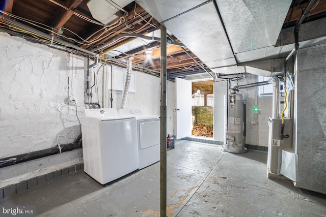 basement featuring water heater and washer and dryer