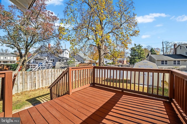 wooden deck featuring a storage unit