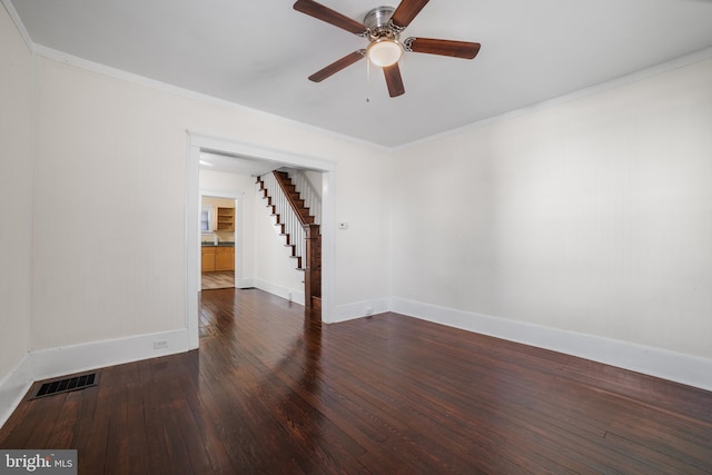 spare room with dark wood-type flooring, ceiling fan, and crown molding