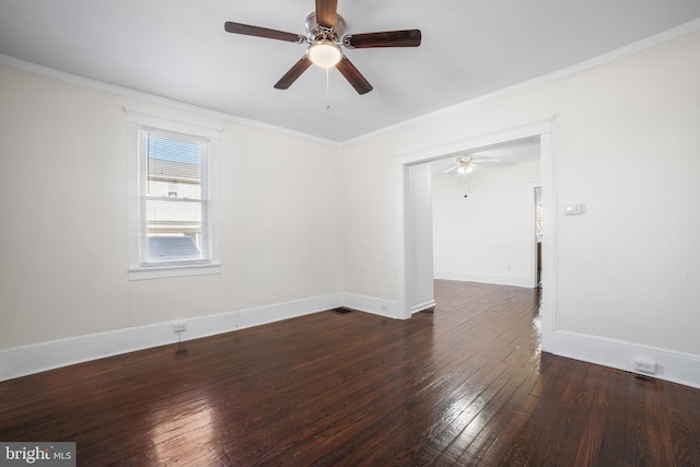 empty room featuring dark wood-type flooring, ceiling fan, and ornamental molding