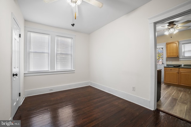 unfurnished room with dark hardwood / wood-style floors and ceiling fan