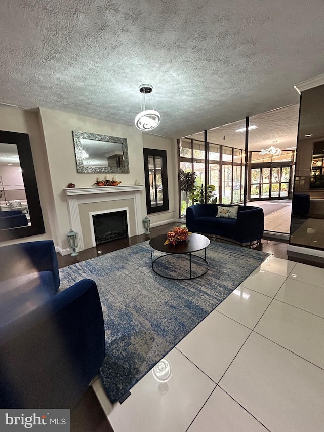 tiled living room featuring a chandelier and a textured ceiling