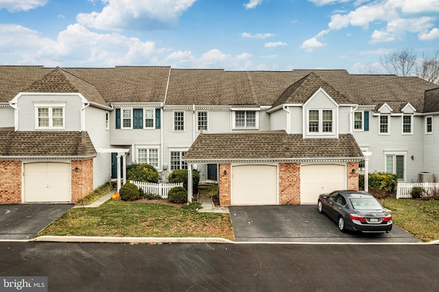 view of property with a front yard and a garage