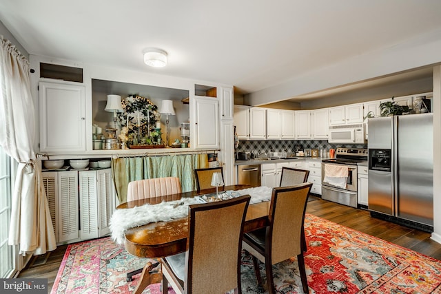 dining space featuring dark wood-type flooring