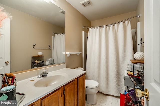 bathroom featuring tile patterned floors, walk in shower, vanity, and toilet