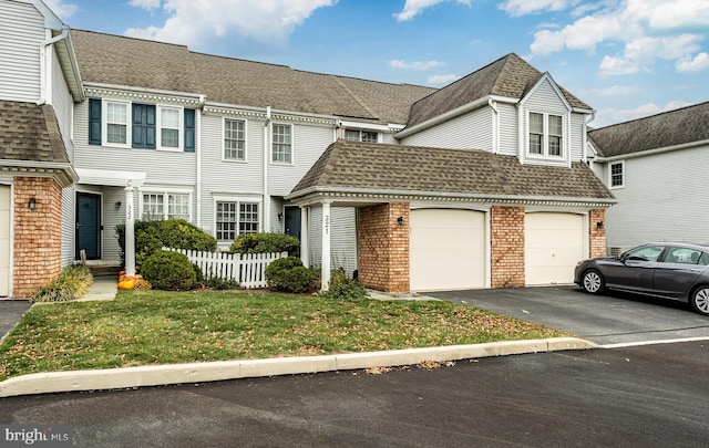 view of front of home with a garage and a front lawn