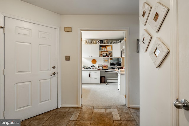 hallway with light colored carpet