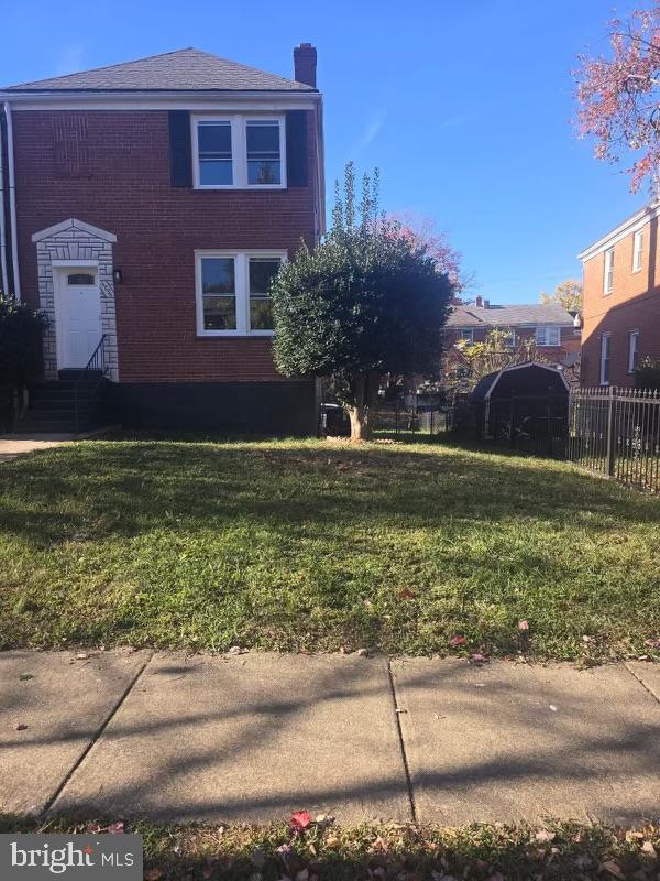 view of side of property with a yard