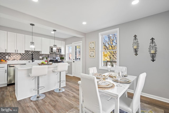 dining room featuring sink and hardwood / wood-style floors