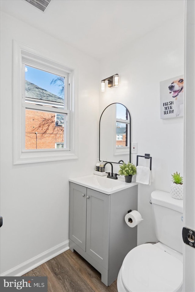 bathroom featuring hardwood / wood-style flooring, vanity, and toilet