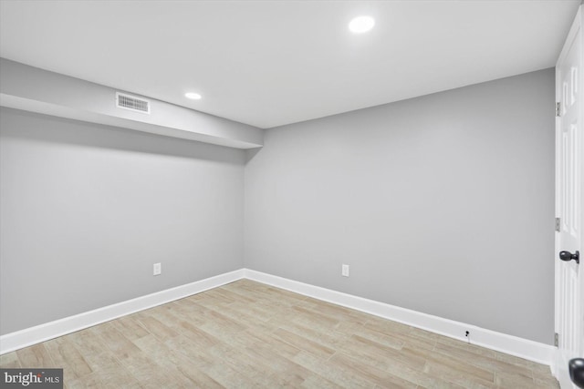 basement with light hardwood / wood-style floors