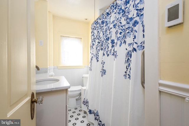 bathroom with vanity, toilet, and tile patterned flooring