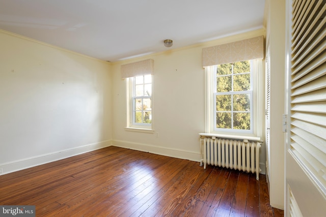 unfurnished room with ornamental molding, dark hardwood / wood-style floors, and radiator