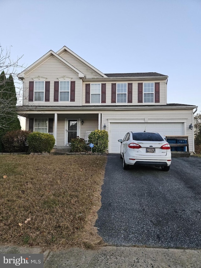 view of front facade featuring a garage and covered porch