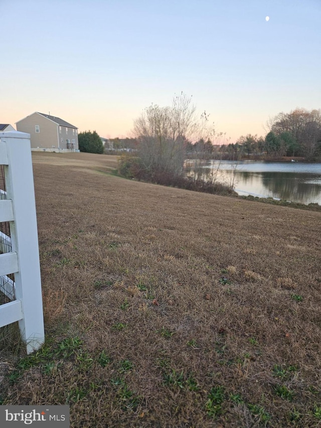 yard at dusk with a water view