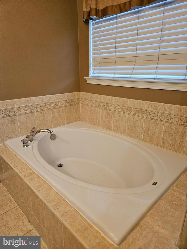 bathroom featuring tile patterned flooring and tiled tub