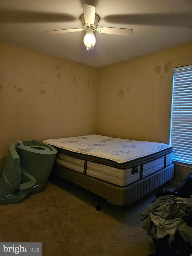 bedroom with ceiling fan and carpet flooring