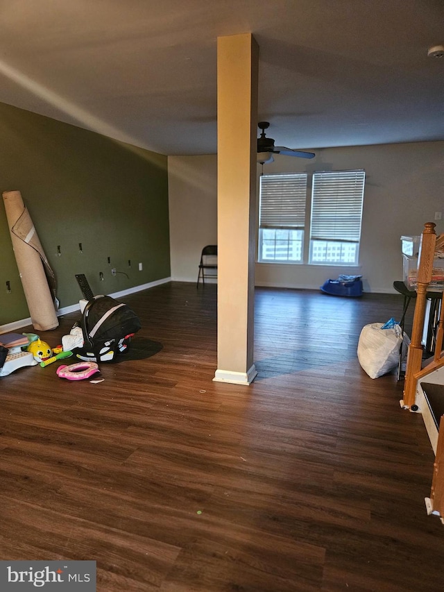 unfurnished living room with dark wood-type flooring and ceiling fan