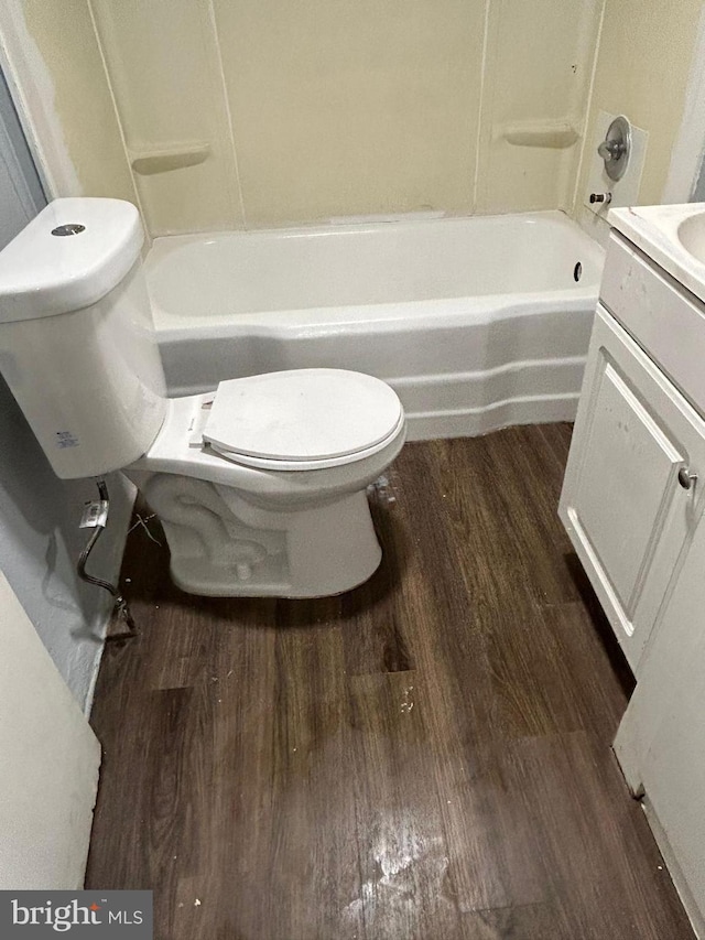 full bathroom with hardwood / wood-style flooring, vanity, toilet, and shower / washtub combination