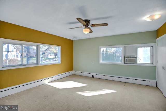 carpeted empty room with a textured ceiling, a wealth of natural light, and ceiling fan