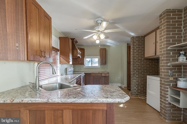 kitchen with sink, white range with electric stovetop, kitchen peninsula, washer / clothes dryer, and light wood-type flooring