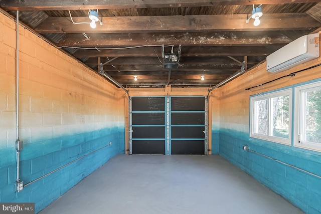 garage featuring a garage door opener and a wall mounted AC