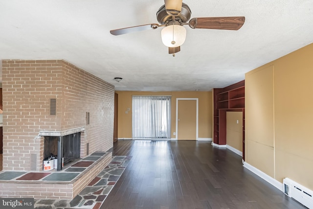 unfurnished living room featuring a textured ceiling, ceiling fan, a baseboard heating unit, a fireplace, and dark hardwood / wood-style floors