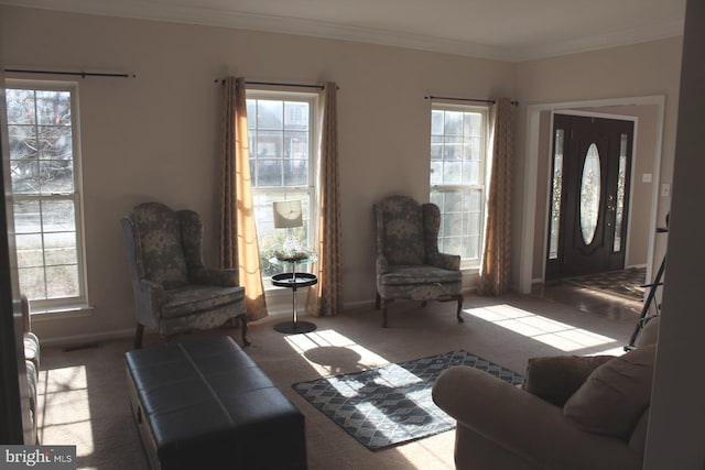 carpeted living room with plenty of natural light and ornamental molding