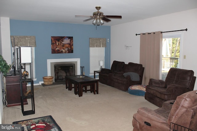 carpeted living room with ceiling fan