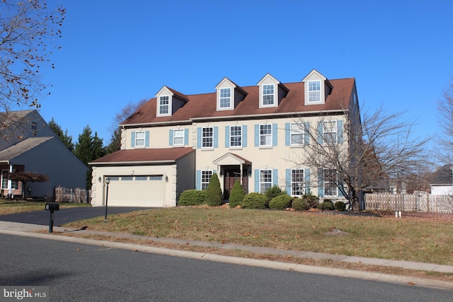 view of front of house with a garage and a front lawn