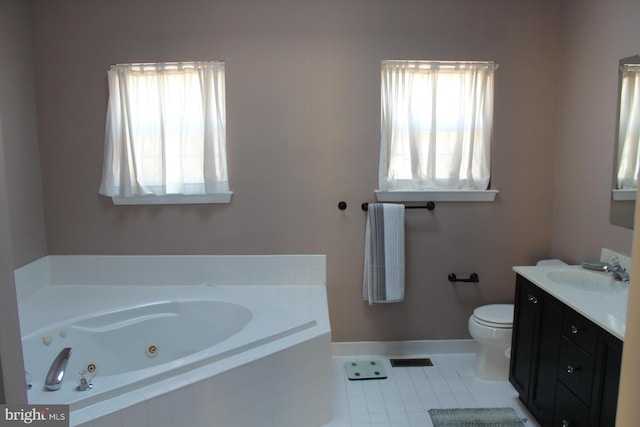 bathroom featuring toilet, vanity, tile patterned floors, and a wealth of natural light