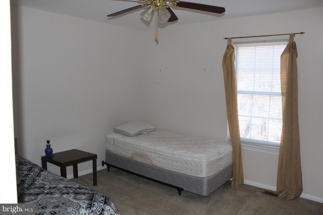 bedroom with carpet floors, multiple windows, and ceiling fan