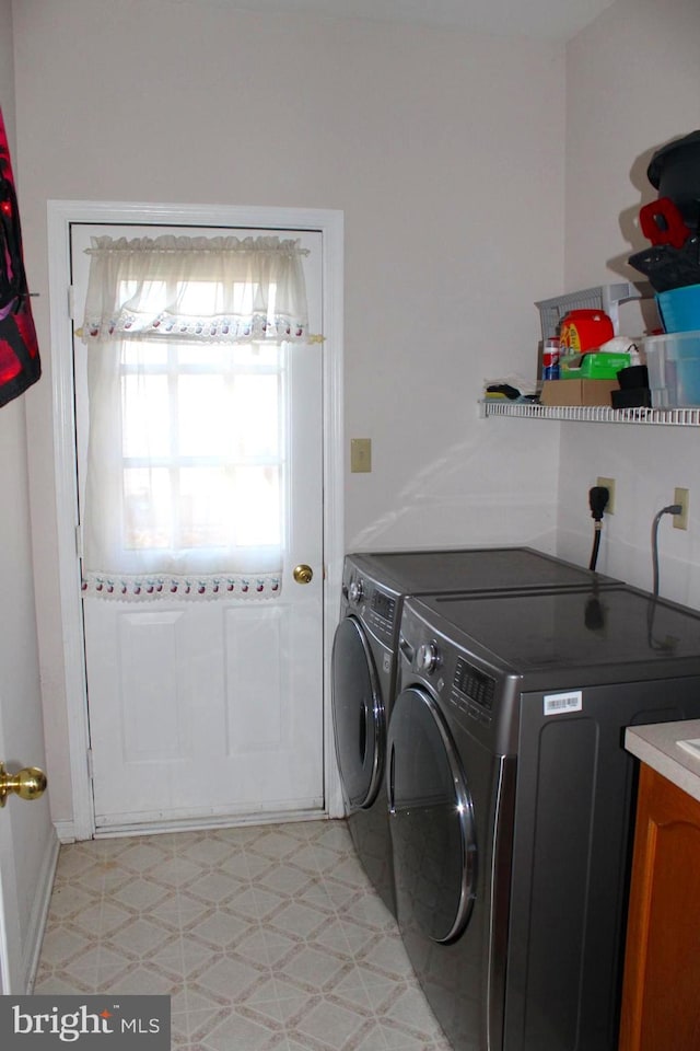 laundry room with independent washer and dryer