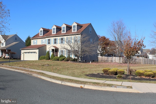 view of front facade with a garage and a front lawn