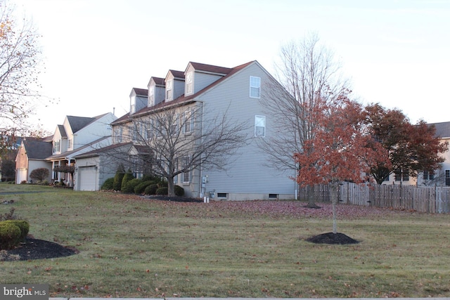 view of side of home with a lawn and a garage