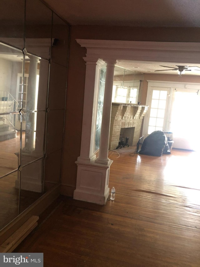 interior space featuring a brick fireplace and hardwood / wood-style floors