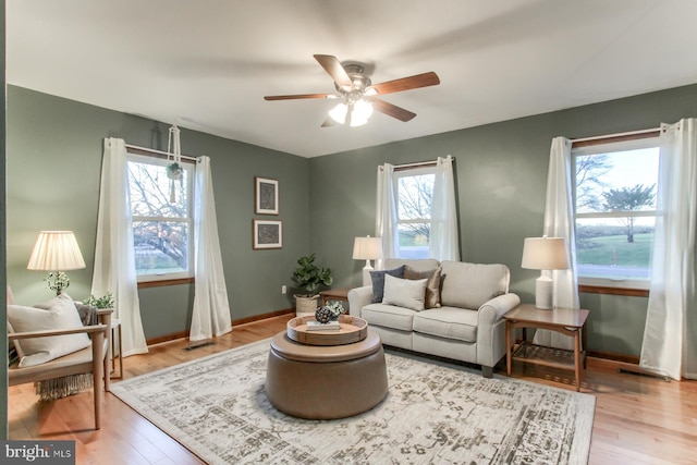 sitting room featuring ceiling fan and light wood-type flooring