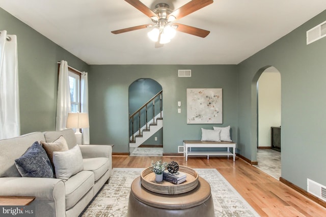 living room with ceiling fan and hardwood / wood-style floors