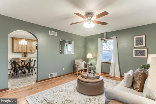 living area with ceiling fan and light wood-type flooring