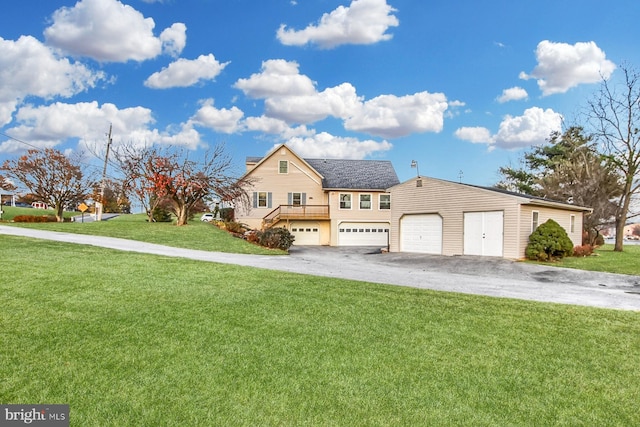 view of front of home with a garage, a deck, and a front lawn